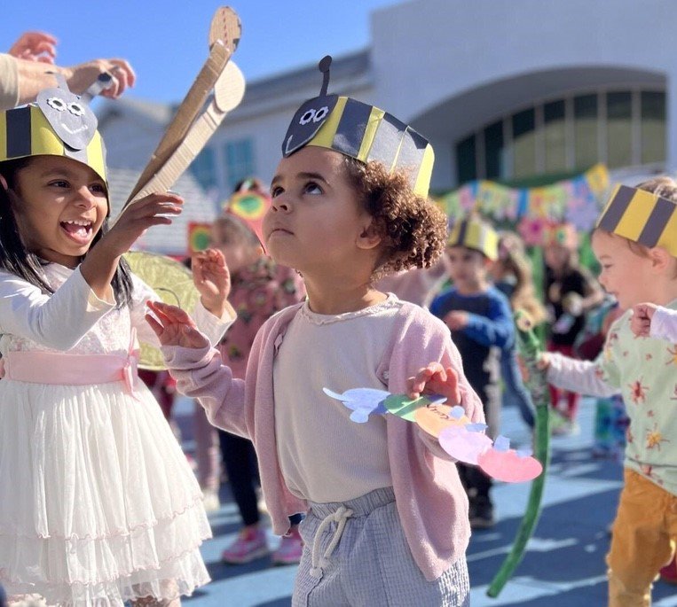 preschool students playing in small pool